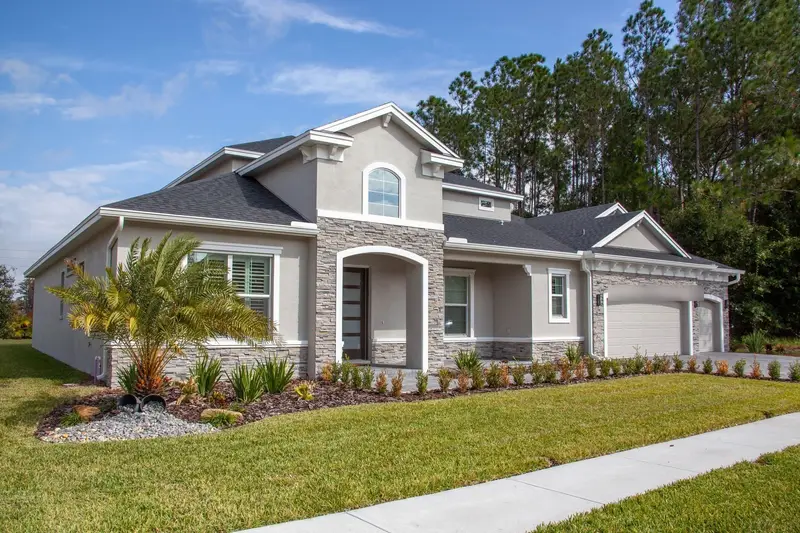Stucco home in Odessa, Florida with a dark architectural shingle roof